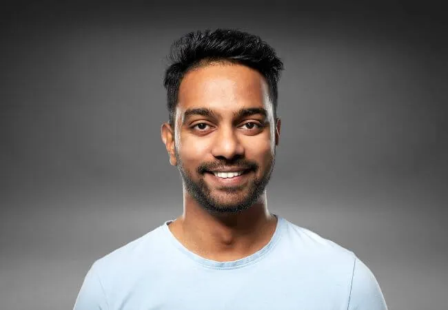Portrait of a man with dense, unshaven hair across the front and sides.
